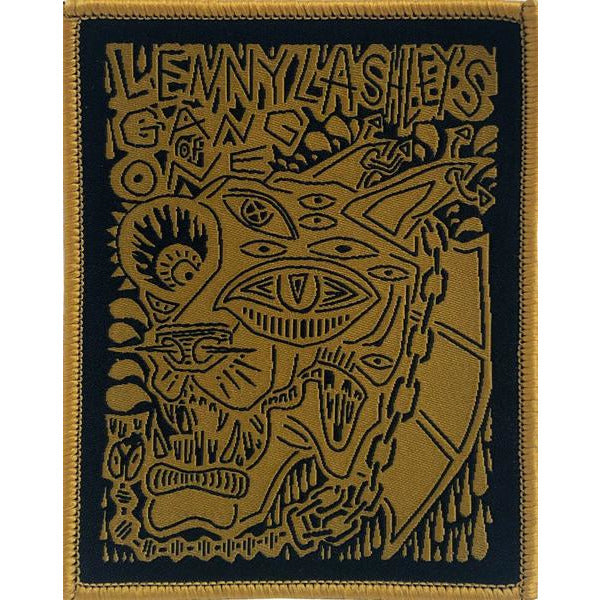 This bold patch from Lenny Lashley&#39;s Gang Of One showcases abstract yellow line art of a multi-eyed, snarling cat with a spiked collar and chain, topped with the band’s name in a striking, stylized font.