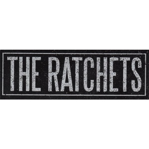 A black rectangular Ratchets sticker showcases THE RATCHETS in bold, white, distressed capitals—ideal as a vinyl or brushed chrome finish sticker.