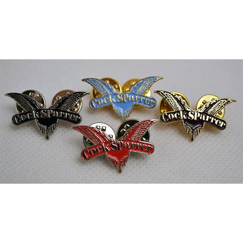 Set of five Cock Sparrer wings lapel pins in black, blue, yellow, silver, and red with silver enamel wings, each featuring the Cock Sparrer brand name. All pins are bird-shaped with outstretched wings and displayed on a light surface.