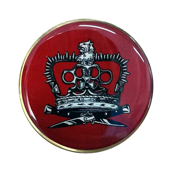 A round Antagonizers ATL pin with a gold metal ring, featuring a red background and a black and white crown topped by a lion, with two crossed swords below.