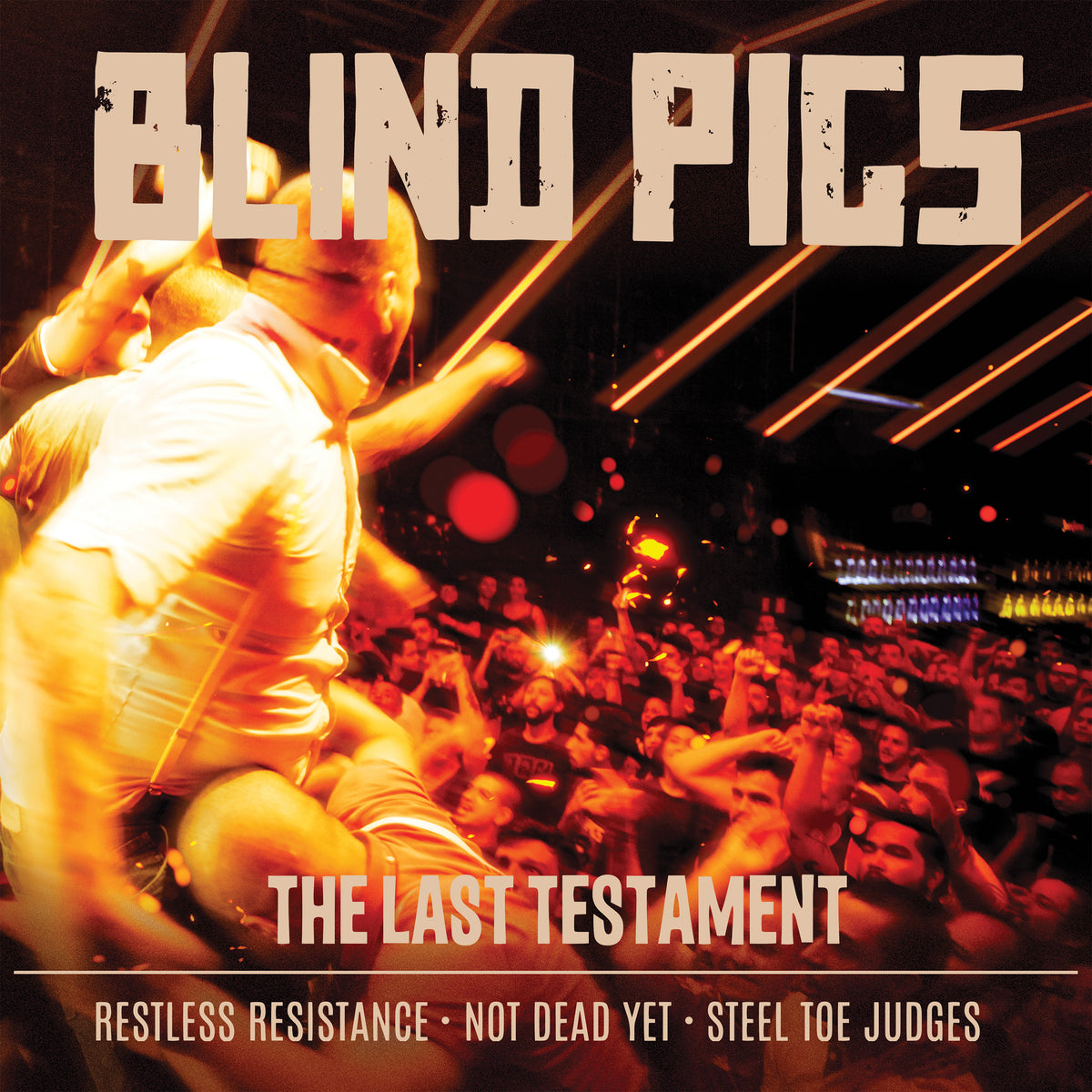 A band rocks the stage before a lively crowd under dramatic lights. The album cover displays: Blind Pigs - The Last Testament, featuring English tracks and Brazilian punk song titles underneath. Brand: Blind Pigs.