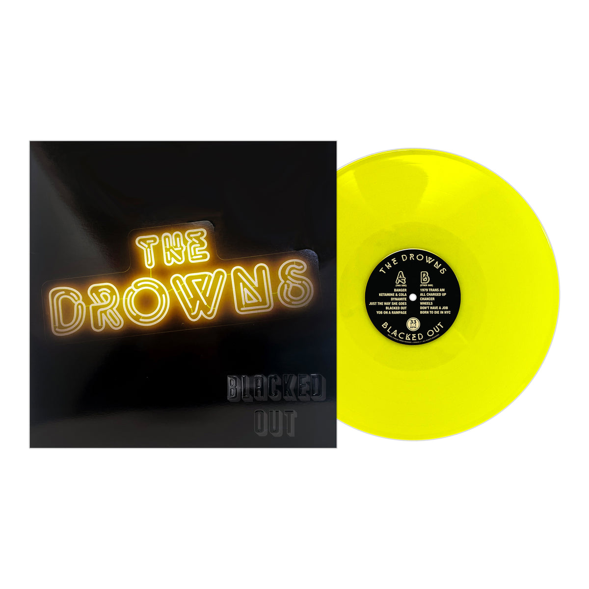 A vibrant yellow vinyl record sits next to its album cover, featuring “The Drowns” in neon yellow lettering and “Blacked Out” in black, channeling the street punk energy of The Drowns’ Blacked Out release.