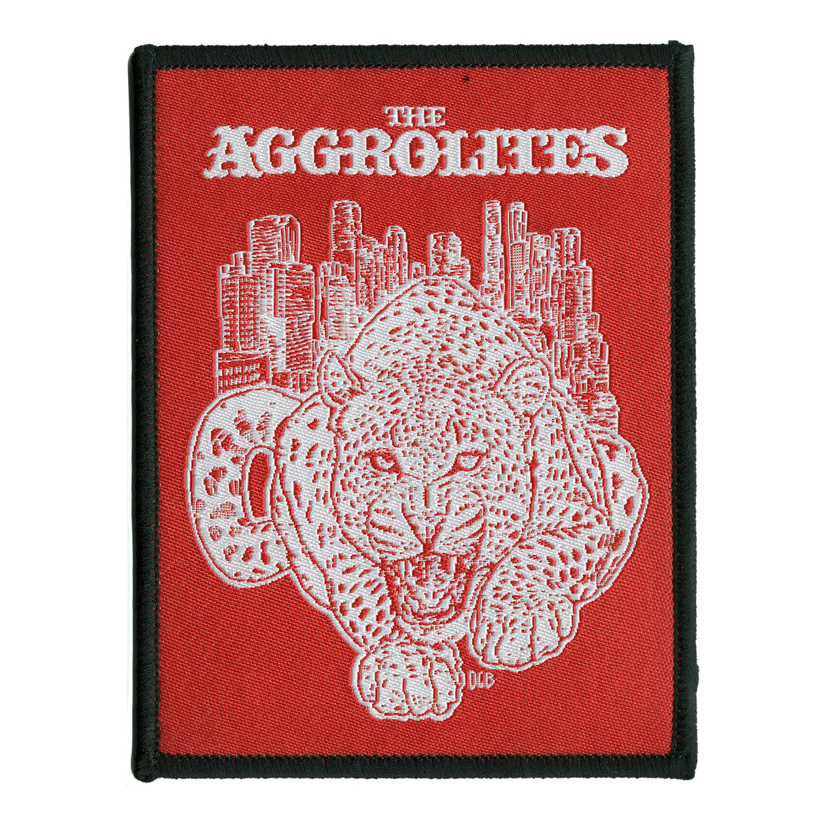A rectangular woven patch by The Aggrolites features a snarling white leopard, the Aggrocat, on a red background with a city skyline and black border. THE AGGROLITES appears in bold white letters at the top.